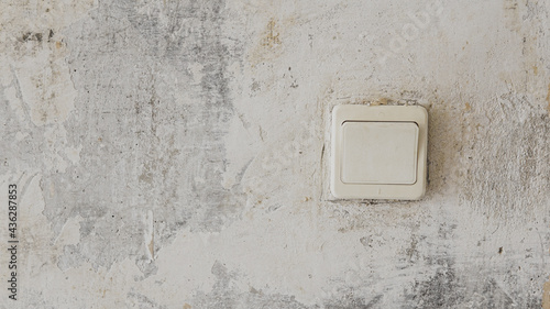 Old electric switch on concrete wall with peeling paint © Evgeniy Klyshnikov