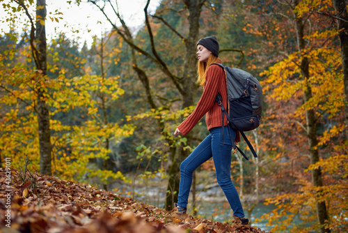 woman hiker walking in the park in autumn nature tall trees landscape leaves model © SHOTPRIME STUDIO