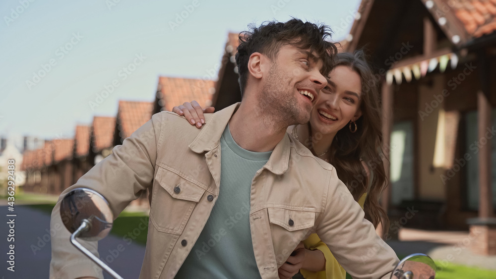 happy man and woman riding motorcycle outside. happy man and woman riding motorcycle outside.