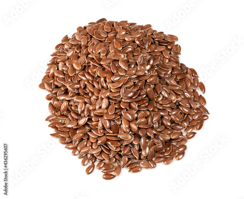 handful of brown flax seeds closeup on white