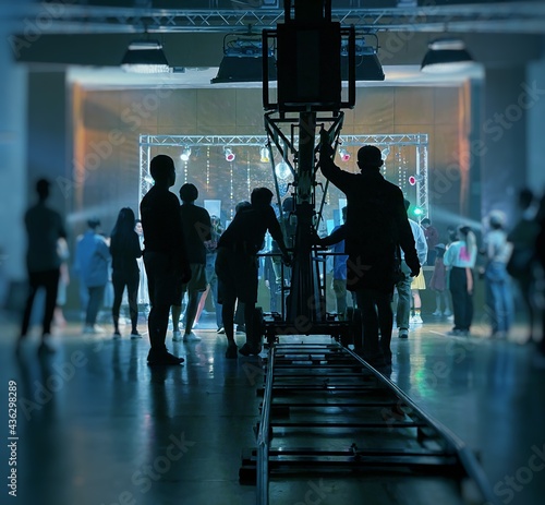 Fotografija Behind the scenes of music video shooting production crew team silhouette and camera equipment in studio