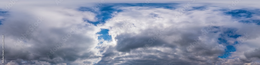 Blue evening sky seamless panorama spherical equirectangular 360 degree view with Cumulus clouds, setting sun. Full zenith for use in 3D graphics, game and aerial drone panoramas as sky replacement.