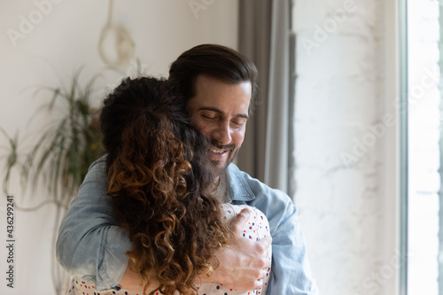 Konstfotografi Happy sincere young man cuddling beloved woman, missing after long separation