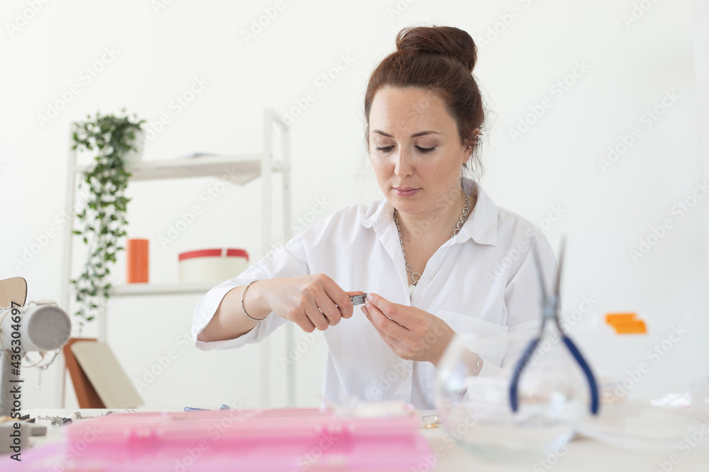 Professional accessories designer making handmade jewelry in studio workshop. Fashion, creativity and handmade concept.