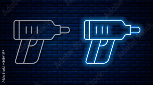 Glowing neon line Electric cordless screwdriver icon isolated on brick wall background. Electric drill machine. Repair tool. Vector