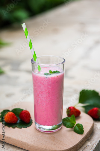 strawberry smoothie or milkshake in glass. Healthy food for breakfast and snack.