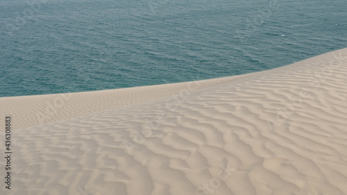 sand ripple effect in the desert sand dunes in sea line  Qatar. selective focus