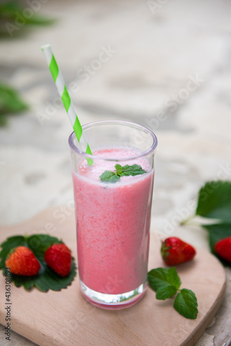 strawberry smoothie or milkshake in glass. Healthy food for breakfast and snack.