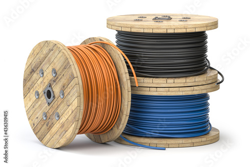 Wire electric cable of different colors on wooden coil or spool isolated on white background. photo