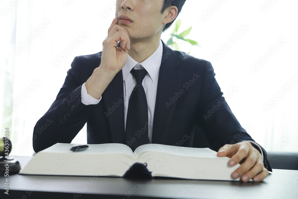 Serious pensive lawyer working at desk in office Serious pensive lawyer working at desk in office