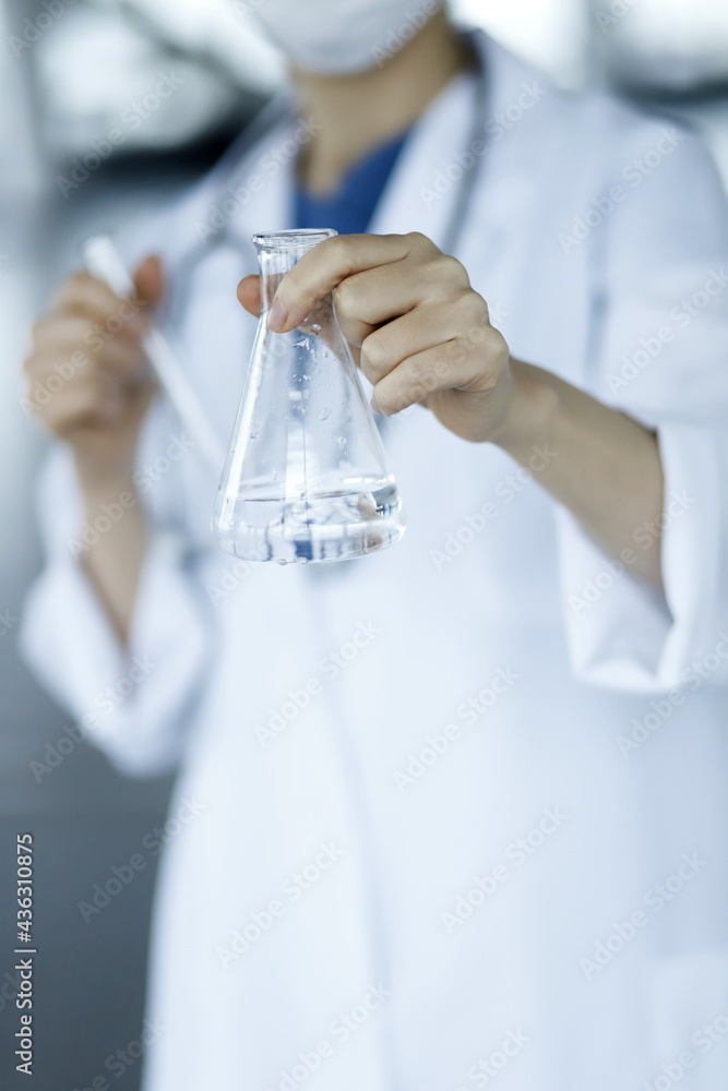 Doctor holding flask. Biotechnology,medicine,chemistry concept
