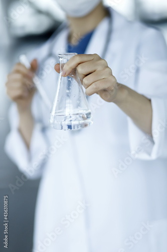 Doctor holding flask. Biotechnology,medicine,chemistry concept