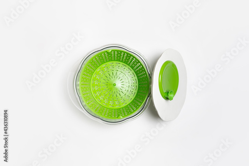 Centrifugal dryer for salad on white background. Mechanical dryer for greens. Plastic Vegetable Spinner.High-resolution photo. photo