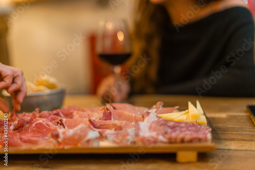 Closeup of delicious Italian cured meat platter served with wine photo