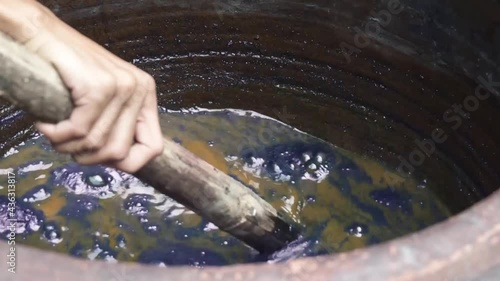 Handmade traditional technique of fabric dyeing in natural indigo colour in Thailand