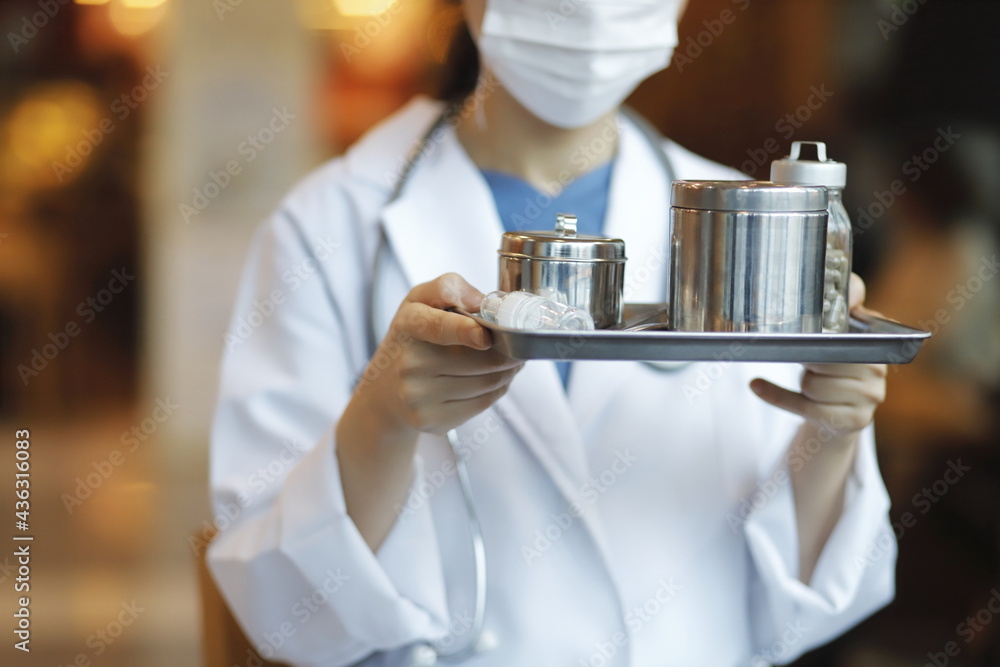 Cropped image of doctor holding medical tray Cropped image of doctor holding medical tray