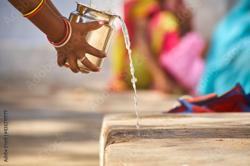 The sacred steps of a temple in India are washed with water. Many Hindus celebrate their religious services, the pujas, in front of their own home altar, in the temple or in the open air. Day.  photo