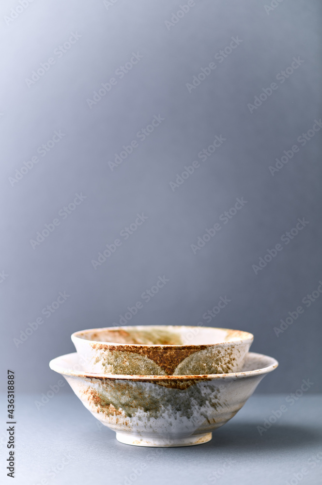 Traditional ceramic bowls on paper background. Copy space. 