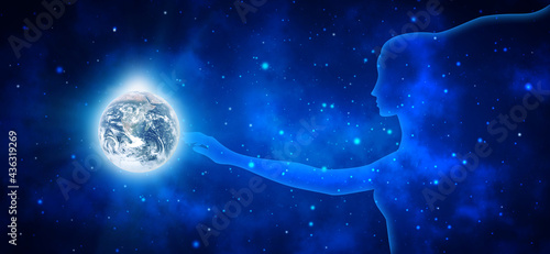 Fototapeta Naklejka Na Ścianę i Meble -  Space woman touches the shining planet Earth on a background of blue stellar universe. 3d illustration. Elements of this image are furnished by NASA
