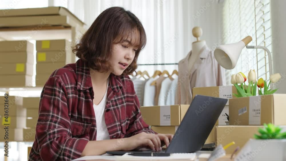 Young asia people woman female e-commerce parcel work check typing talk to customer on notebook for box shipping online fulfillment sme dropshipping digital dispatch app clothes fashion supply chain. Young asia people woman female e-commerce parcel work check typing talk to customer on notebook for box shipping online fulfillment sme dropshipping digital dispatch app clothes fashion supply chain.