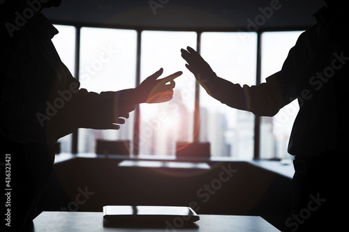 Silhouette business people arguing in meeting room