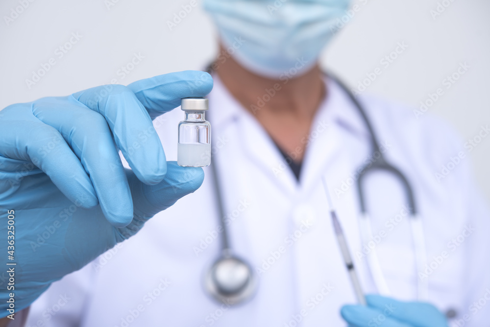 Corona virus vaccination, Doctor with syringe and needle drawing coronavirus vaccine for injection against covid-19 Corona virus vaccination, Doctor with syringe and needle drawing coronavirus vaccine for injection against covid-19