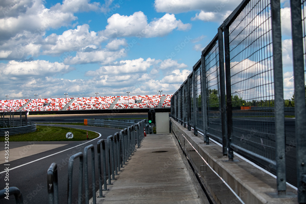 Obraz premium racing sports cars at the circuit race along the track on a sunny day 