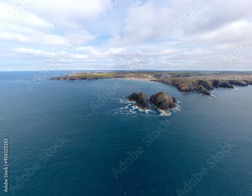 Holywell bay islands also know as gull or carters rocks in cornwall england uk aerial drone