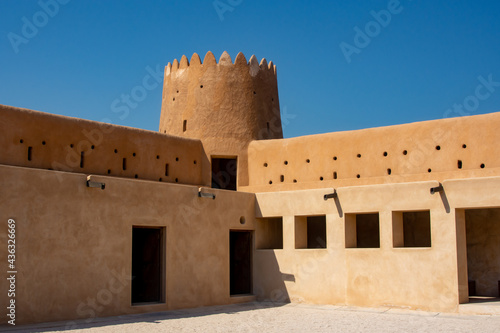 Fotografie Interior corner of Al Zubarah Fort with circular tower and two levels of solider