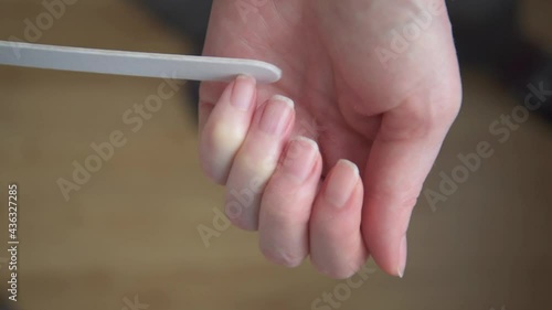 Women's hands close-up. The girl makes a manicure. Nail file