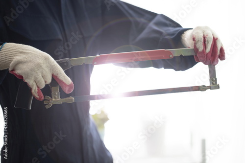 Close up of engineer holding saw