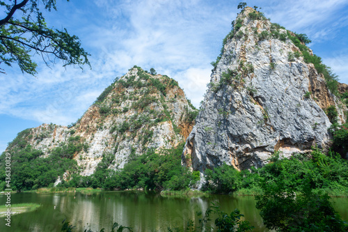 Landscape Mountain View with water reflection at Khao ngoo or snake stone mountain park with blue sky in Ratchaburi, Thailand, lake and rock hill relax travel place