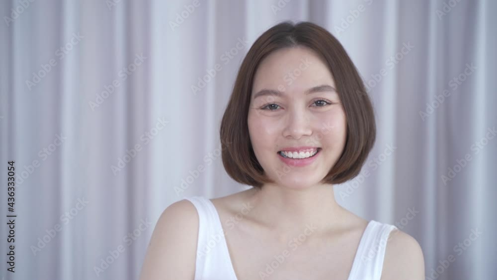 portrait of asian woman short hair in white smiling confidence face expression on background. attractive beautiful female 30's dark brown hair posing for fashion. confident and thinking act. portrait of asian woman short hair in white smiling confidence face expression on background. attractive beautiful female 30's dark brown hair posing for fashion. confident and thinking act.