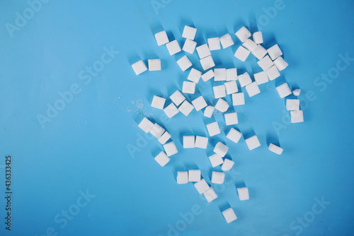 top view of sugar cube on blue background 