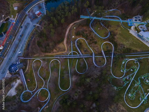 фотографія Aerial view of curvy bobsleigh tracks in a beautiful forest