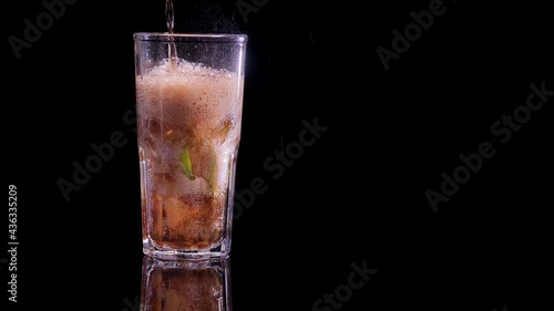 Wallpaper Mural a cola is poured into a glass of ice and lime, on a black background Torontodigital.ca
