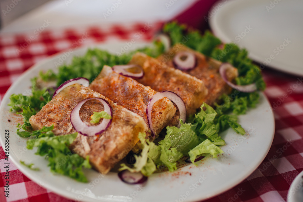 Pihtije i Duvan cvarci - traditional Balkan food. Dish in restarurant.