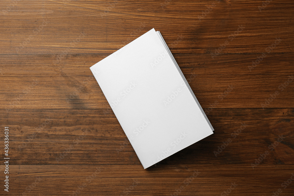 Blank paper brochure on wooden table, top view. Mockup for design Blank paper brochure on wooden table, top view. Mockup for design