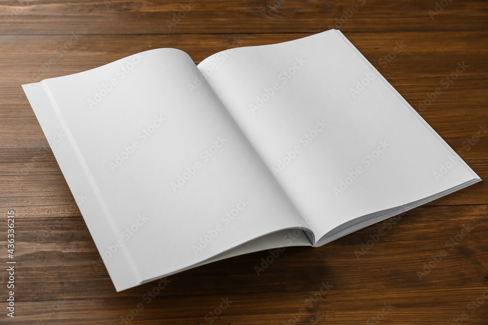 Open blank paper brochure on wooden table. Mockup for design Open blank paper brochure on wooden table. Mockup for design