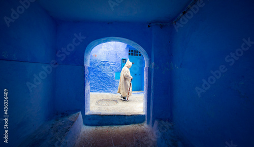 man walking in a street in Chefchaouen, Morocco © Fernando