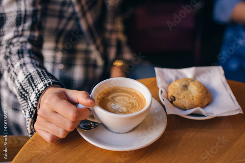 Espresso coffee holding girl in cafeteria 