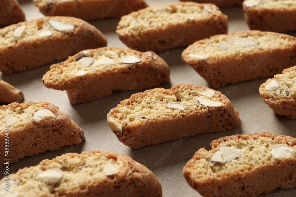 Traditional Italian almond biscuits (Cantucci) on parchment paper, closeup