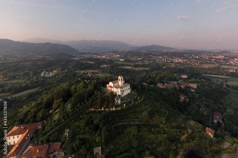 Montevecchia view from the sky with the sanctuary and the hills around at sunset.