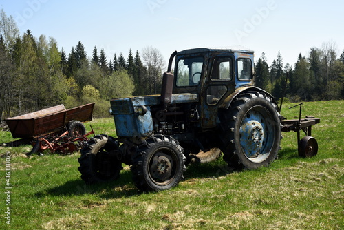 Old blue russian agricultural tractors in the field. Agricultural machinery in the farm. Special Agricultural Equipment
