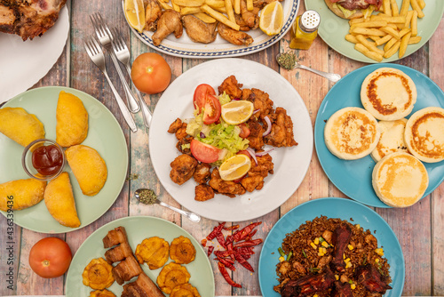set of assorted dishes of typical Colombian food inside beautiful blue and green plates