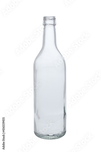 Empty transparent glass bottle for alcoholic beverages. Front view on white background
