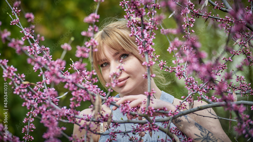 Beautiful young woman during spring flowering Beautiful young woman during spring flowering
