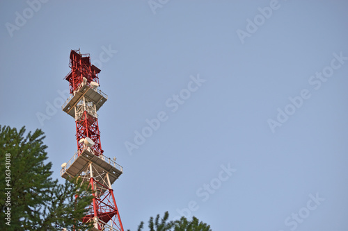 TV tower antenna with tree and TV center building