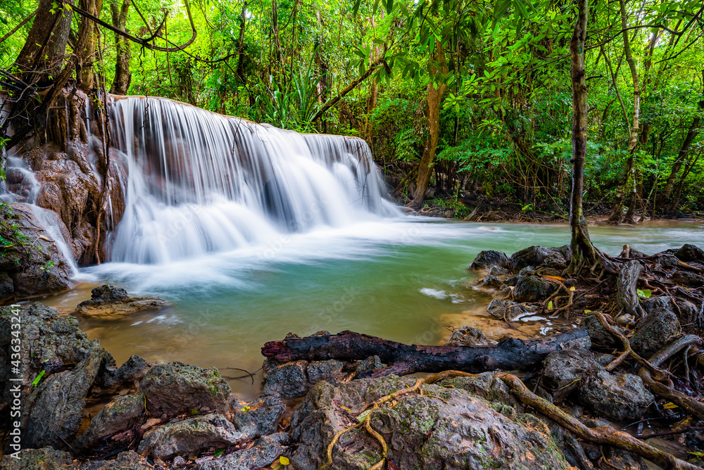 Obraz premium Waterfall and blue emerald water color in Huay Mae Khamin national park. Huay Mae Khamin, Beautiful nature rock waterfall steps in tropical rainforest at Kanchanaburi province, Thailand