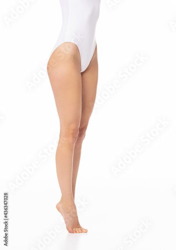 Close-up of a beautiful and fit female figure. Studio photo of young woman's body in swimsuit.